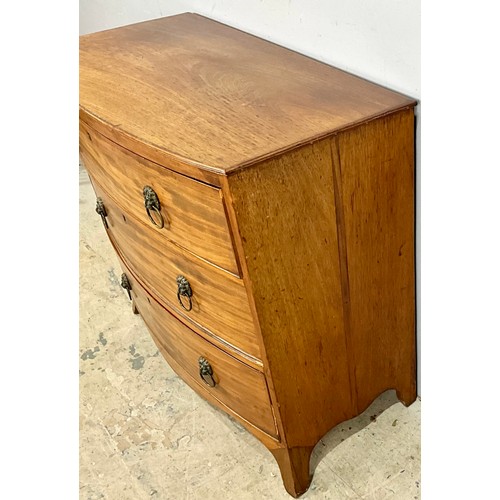 594 - BOW FRONT CHEST OF THREE DRAWERS ON SPLAY BRACKET FEET WITH LION MASK HANDLES. 65cm h x 92cm w x 47c... 