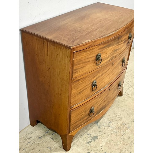 594 - BOW FRONT CHEST OF THREE DRAWERS ON SPLAY BRACKET FEET WITH LION MASK HANDLES. 65cm h x 92cm w x 47c... 