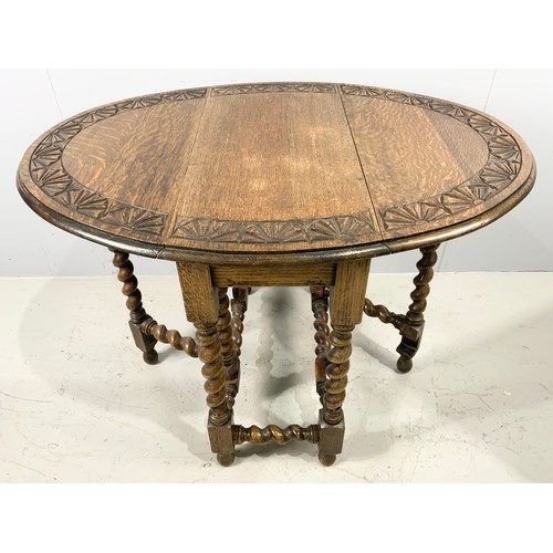 562 - CARVED OAK GATELEG TABLE EXTENDED 102cm x 75cm