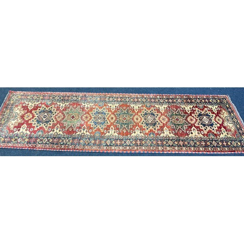 721 - RED GROUND RUNNER, APPROX. 285 X 85 cm