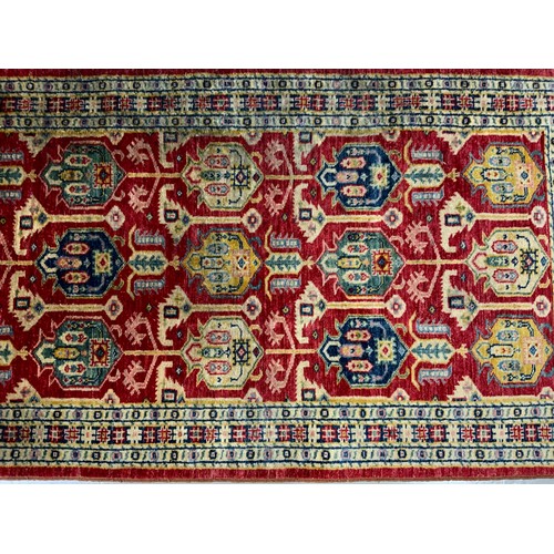 719 - RED GROUND RUG 154cm x 87cm