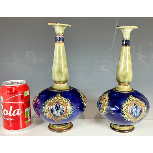 240 - A PAIR OF ROYAL DOULTON STONEWARE BOTTLE VASES, BLUE GROUND WITH ART NOUVEAU FLORAL PATTERNS AND SLE... 