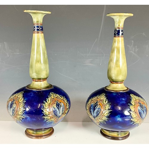 240 - A PAIR OF ROYAL DOULTON STONEWARE BOTTLE VASES, BLUE GROUND WITH ART NOUVEAU FLORAL PATTERNS AND SLE... 