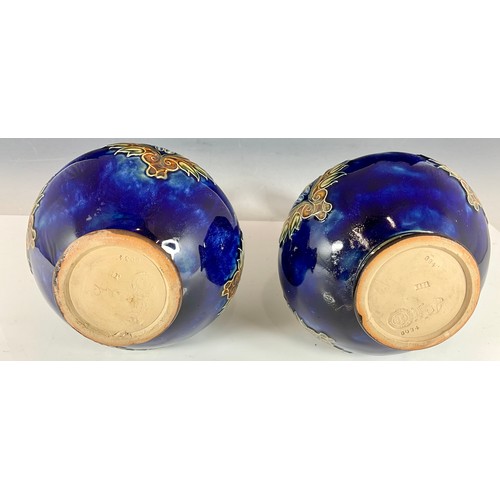 240 - A PAIR OF ROYAL DOULTON STONEWARE BOTTLE VASES, BLUE GROUND WITH ART NOUVEAU FLORAL PATTERNS AND SLE... 