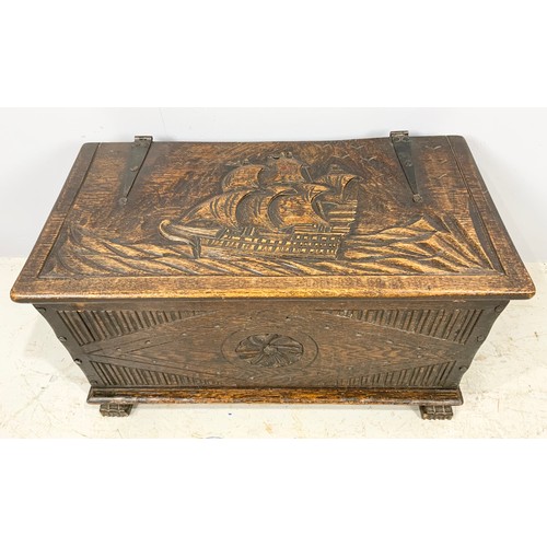 554 - CARVED OAK BOX WITH STRAP HINGES WITH CARVED GALLEON DECORATION WIDTH 81cm