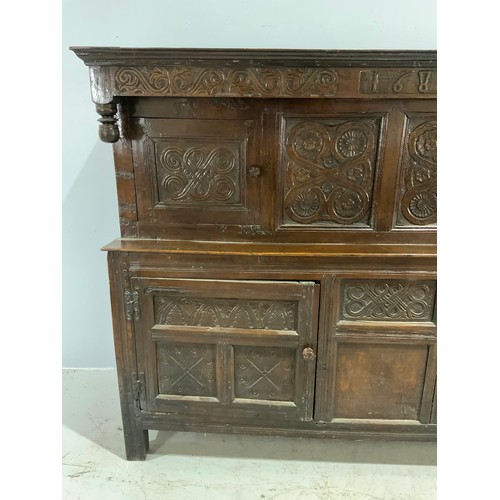 593 - CARVED OAK COURT CUPBOARD ON STILE FEET, CARVED DATE 1689 BUT BELIEVED TO BE LATER, APPROX. 196 cm
P... 