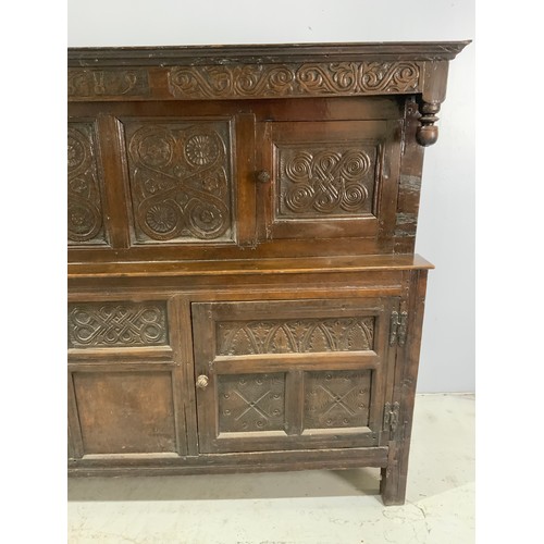 593 - CARVED OAK COURT CUPBOARD ON STILE FEET, CARVED DATE 1689 BUT BELIEVED TO BE LATER, APPROX. 196 cm
P... 