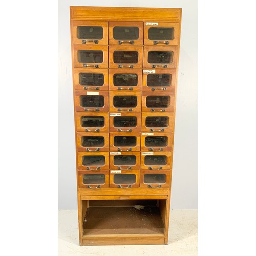 591 - VINTAGE HABERDASHERY CABINET – MID 20TH CENTURY OAK WITH GLASS FRONTED DRAWERS ABOVE A TAMBOUR FRONT... 