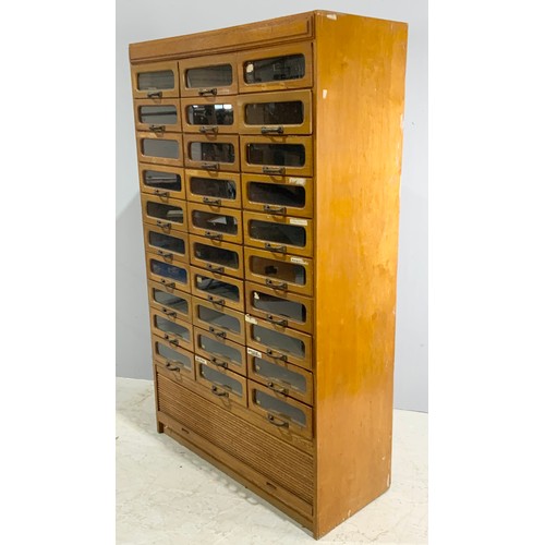 590 - VINTAGE HABERDASHERY CABINET – MID 20TH CENTURY OAK WITH GLASS FRONTED DRAWERS ABOVE A TAMBOUR FRONT... 