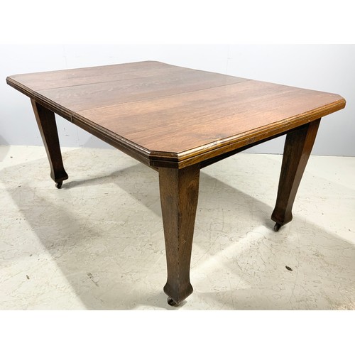 552 - ARTS AND CRAFTS STYLE OAK DINING  TABLE WITH A LEAVE  145cm x 104cm  WHICH WE ARE ADVISED WERE PURCH... 