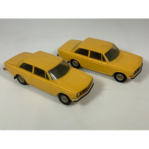 99 - TWO PLASTIC LARGE SCALE VOLVO CARS, MADE IN FINLAND, APPROX 22 CM LONG