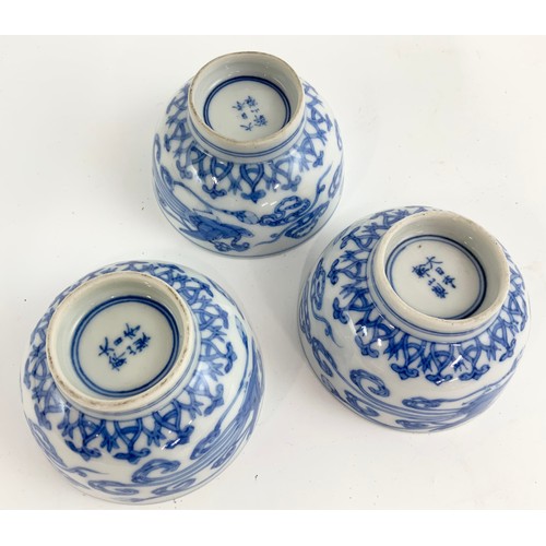 235 - THREE ORIENTAL BLUE AND WHITE TEA BOWLS EACH WITH A SIX CHARACTER MARK TOGETHER WITH A RICE BOWL