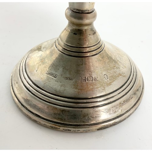 357 - SMALL LOADED SILVER CANDLESTICK AND A TWO OF BRASS DITTO