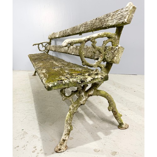 555 - WOODEN BENCH WITH CAST IRON STYLISED BRANCH WINGS WIDTH 242cm