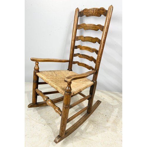 708 - LADDER BACK ROCKING CHAIR WITH RUSH SEAT &  A SPINDLE BACK ARM CHAIR WITH RUSH SEAT