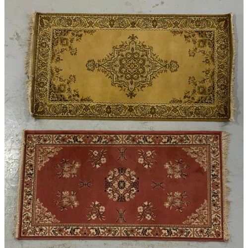 733 - 2 MACHINE MADE RUGS 1) green ground approx 89x164cm
2)pink ground approx 82x153cm