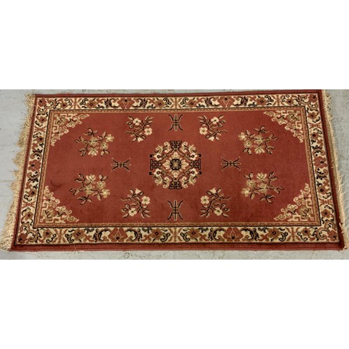 733 - 2 MACHINE MADE RUGS 1) green ground approx 89x164cm
2)pink ground approx 82x153cm