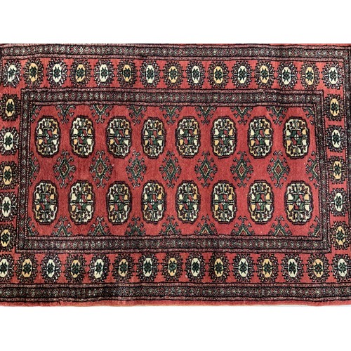 731 - SMALL ROSE COLOURED PERSIAN BOKHARA RUG APPROX 135X79CM