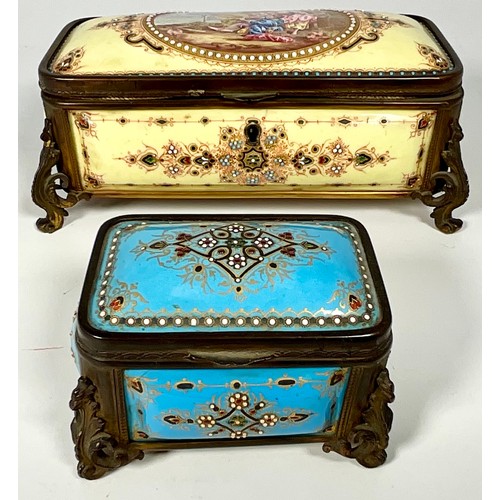 174 - 2 DECORATIVE CERAMIC CIGARETTE BOXES EACH EMBELLISHED WITH BEADING AND WITH ORNAMENTAL FEET, POSSIBL... 