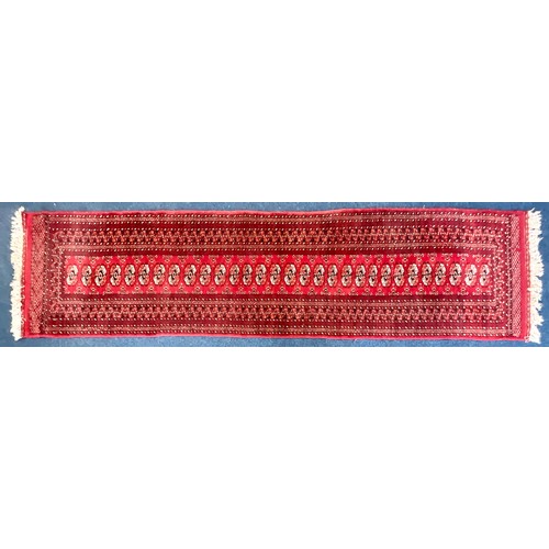 741 - RED GROUND HAND KNOTTED BOKHARA RUNNER. Approx. 335 x 80cm