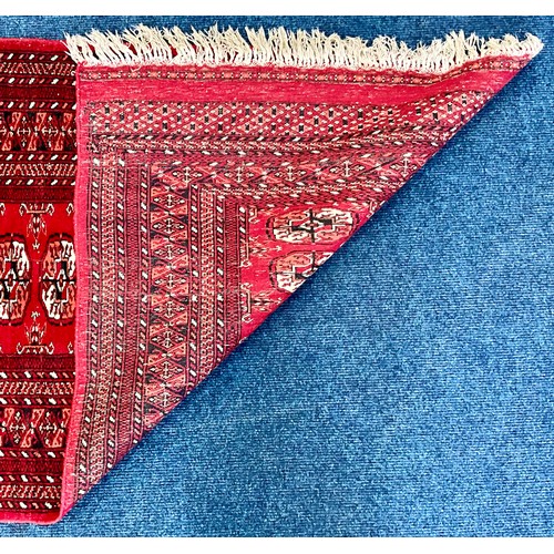 741 - RED GROUND HAND KNOTTED BOKHARA RUNNER. Approx. 335 x 80cm