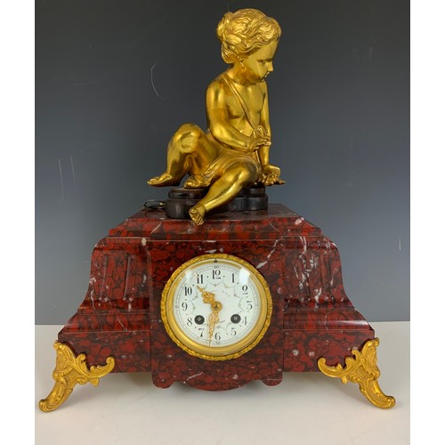 284 - IMPRESSIVE FRENCH CLOCK GARNITURE WITH A FRENCH RED MARBLE CLOCK MOUNTED WITH A CHERUB AND TWO RED M... 