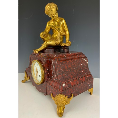 284 - IMPRESSIVE FRENCH CLOCK GARNITURE WITH A FRENCH RED MARBLE CLOCK MOUNTED WITH A CHERUB AND TWO RED M... 