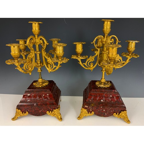 284 - IMPRESSIVE FRENCH CLOCK GARNITURE WITH A FRENCH RED MARBLE CLOCK MOUNTED WITH A CHERUB AND TWO RED M... 