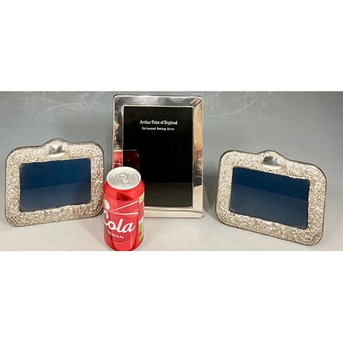 410 - PAIR OF EMBOSSED SILVER PHOTO FRAMES AN ARTHUR PRICE PHOTO FRAME AND A MINIATURE EMBOSSED PHOTO FRAM... 