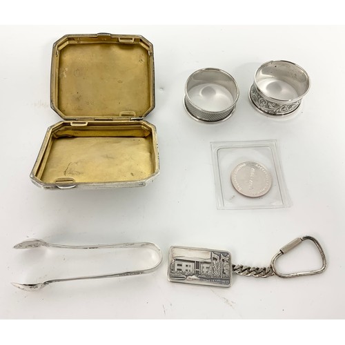 362 - PAIR OF SILVER SERVIETTE RINGS, TONGS, A SILVER CIGARETTE CASE, A SILVER INGOT AND A COMMEMORATIVE C... 