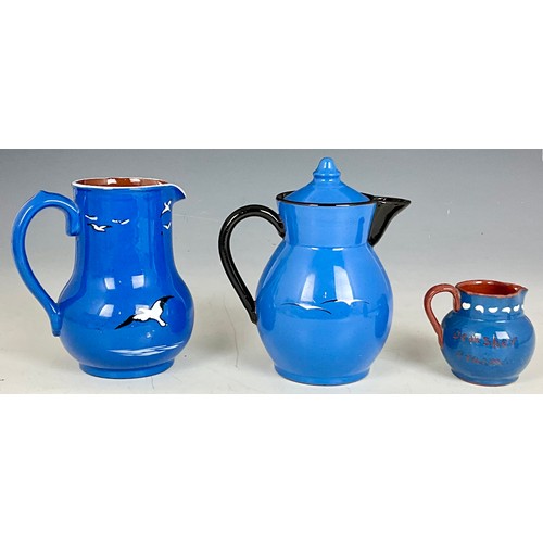 191 - HAND PAINTED STUDIO POTTERY TEAPOT AND TWO JUGS OF SIMILAR DESIGN DECORATED WITH SEAGULLS