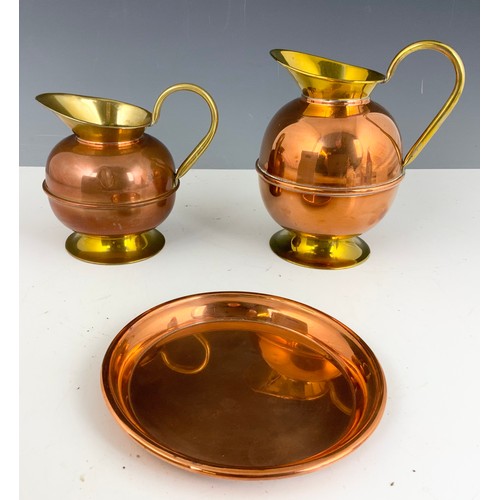 317 - A PAIR OF BRASS AND COPPER JUGS AND A COPPER PLATE