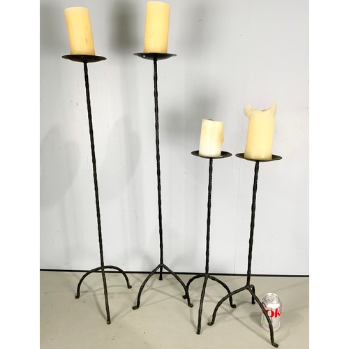 323 - TWO PAIRS OF WROUGHT IRON TABLE CANDLESTICKS