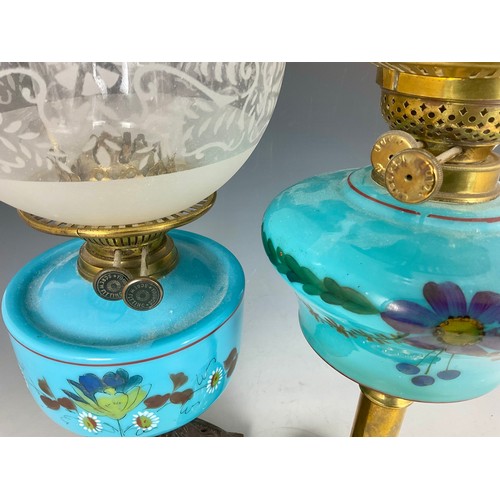 275 - 2 OIL LAMPS, EACH HAVING A BLUE OPALINE GLASS WITH FLORAL DECORATION RESERVOIR AND ETCHED SHADE, TAL... 