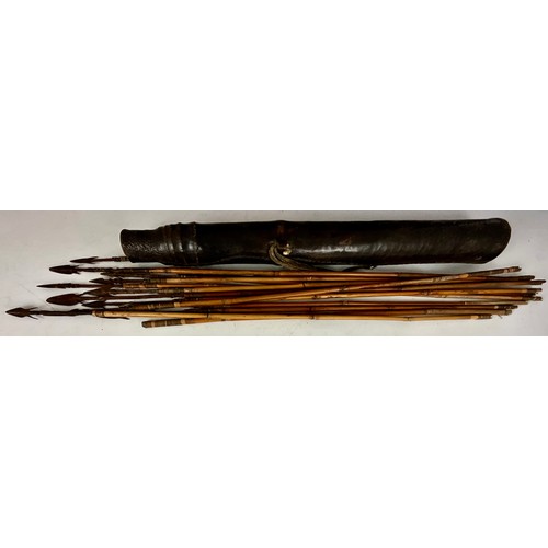 355 - AN ANIMAL HIDE QUIVER OF CYLINDRICAL FORM CONTAINING STEEL TIPPED BAMBOO ARROWS