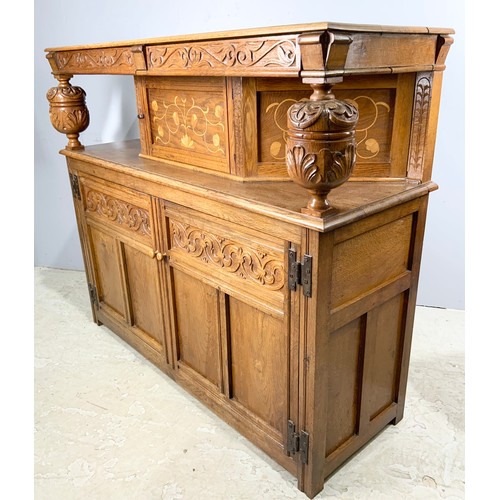 585 - LIGHT OAK COURT CUPBOARD WITH INLAID DECORATION WIDTH 137cm