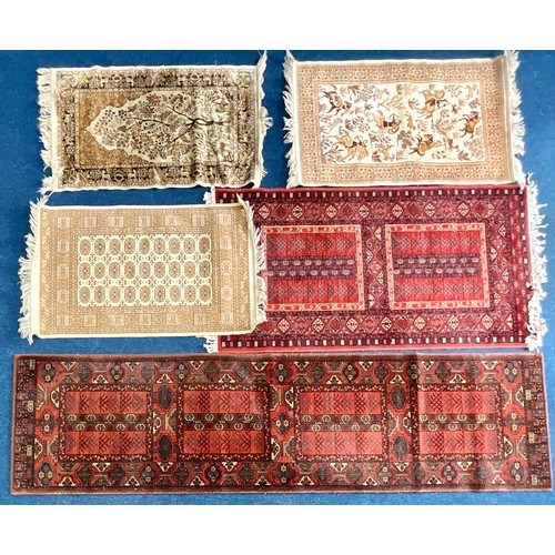 749 - 3 MACHINE MADE CREAM GROUND RUGS AND 2 MACHINE MADE RED GROUND RUNNERS. Largest 263cm x 67cm.