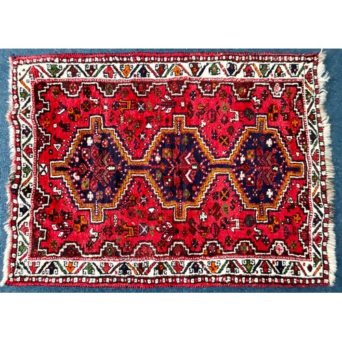 748 - A NORTH WEST PERSIAN TRADITIONAL RED GROUND QASHQAI RUG. Approx. 145cm x 113cm