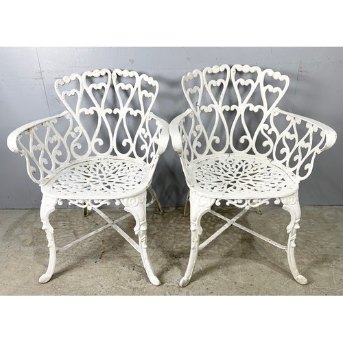 565 - TWO CAST 2 GARDEN CHAIRS WITH A SIMILAR TABLE 80cm DIAMETER