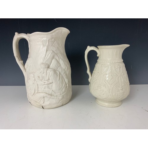 181 - TWO RELIEF DECORATED JUGS, ONE BEARING BRITISH REGISTRATION MARK, THE OTHER A/F