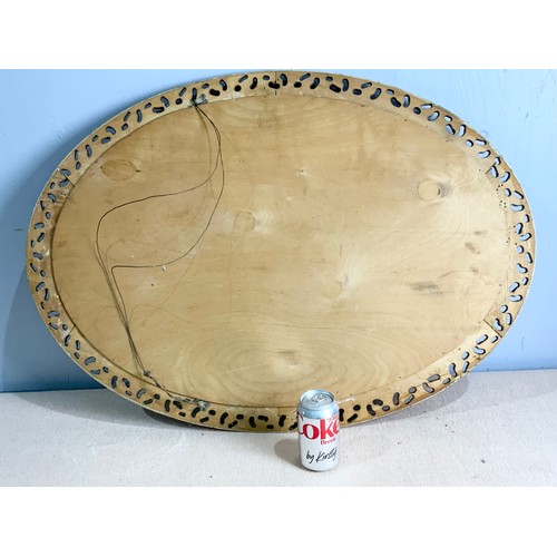 69 - OVAL BEVELED MIRROR IN ORNATE GILT FRAME  88cm x 63cm