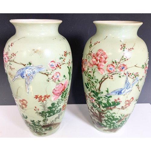 173 - PAIR OF ORIENTAL CELADON GROUND VASES WITH EMBOSSED  BIRD & FLORAL DECORATION 30cm TALL