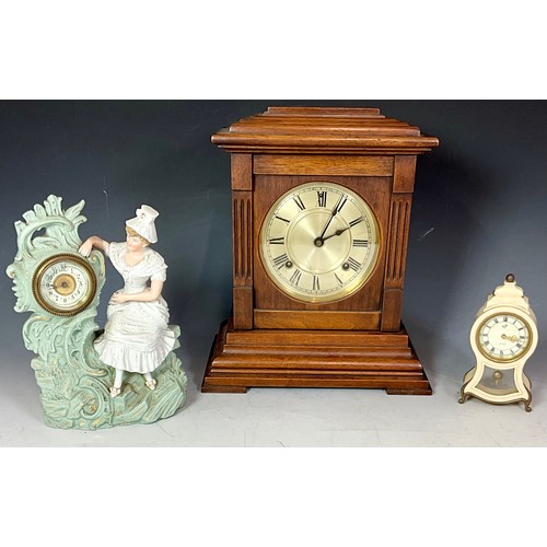 296 - THREE MANTEL CLOCKS - A 19TH CENTURY FRENCH FIGURAL PORCELAIN CLOCK, AN ANTIQUE GERMAN STAG BAKELITE... 