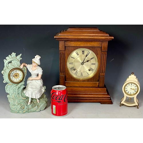 296 - THREE MANTEL CLOCKS - A 19TH CENTURY FRENCH FIGURAL PORCELAIN CLOCK, AN ANTIQUE GERMAN STAG BAKELITE... 