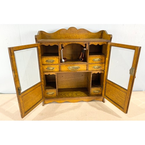 392 - OAK SMOKERS CABINET AND CONTENTS INCLUDING PIPES WIDTH 55cm . 62cm TALL