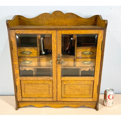 392 - OAK SMOKERS CABINET AND CONTENTS INCLUDING PIPES WIDTH 55cm . 62cm TALL