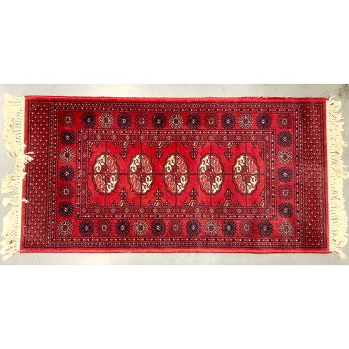 743 - RED GROUND RUG MACHINE NADE 136cm x 69cm & A CREAM GROUND RUG PAKISTAN BOKHARA 87cm x 66cm