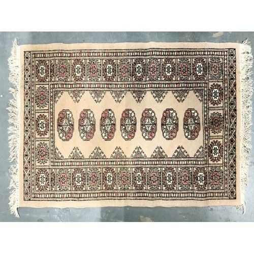 743 - RED GROUND RUG MACHINE NADE 136cm x 69cm & A CREAM GROUND RUG PAKISTAN BOKHARA 87cm x 66cm