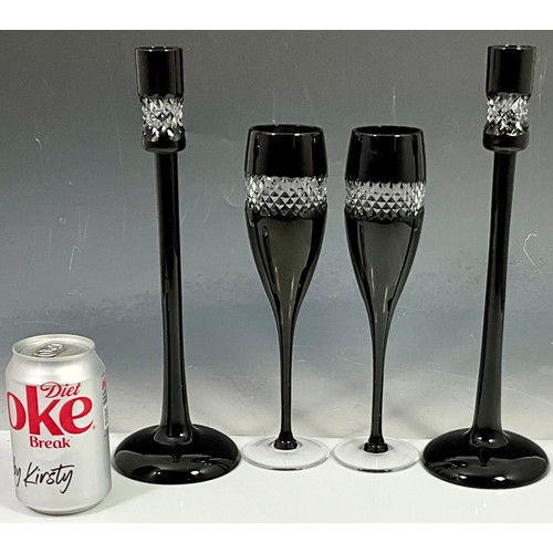 234 - JOHN ROCHA FOR WATERFORD CRYSTAL, PR. BLACK GLASS CANDLESTICKS AND PR. MATCHING CHAMPAGNE FLUTES