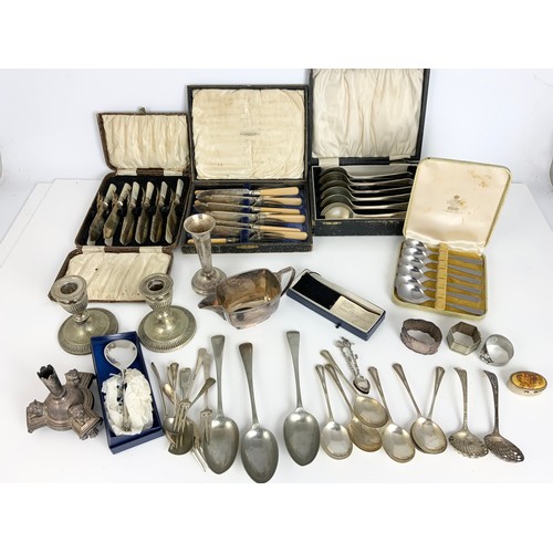 271 - LARGE QUANTITY OF SILVER  PLATED WARE. ETC INC BOXED CUTLERY. , INTRESTING CANDLESTICK WITH CAST LIO... 